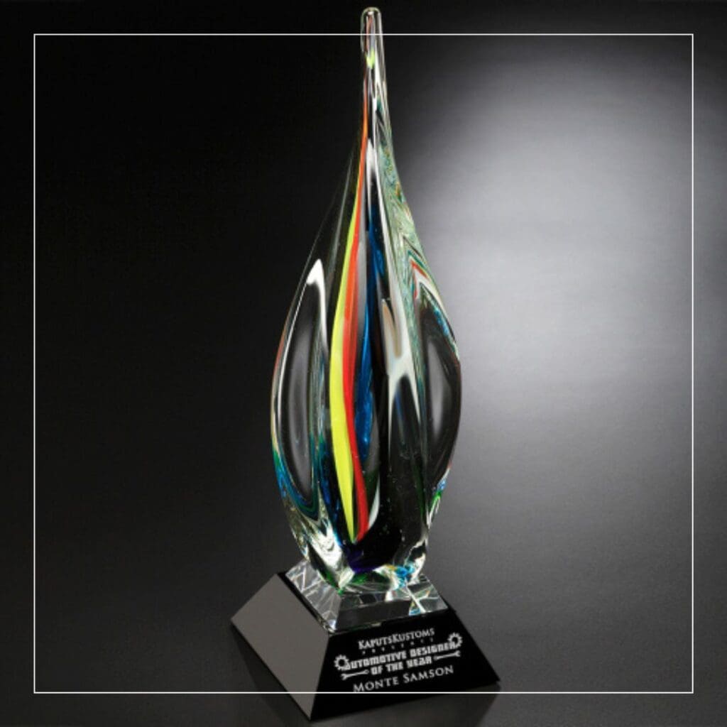 A colorful glass award in a drop shape