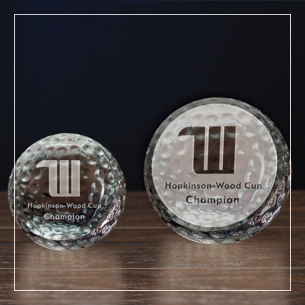 A crystal golf ball-shaped custom award with an optical design