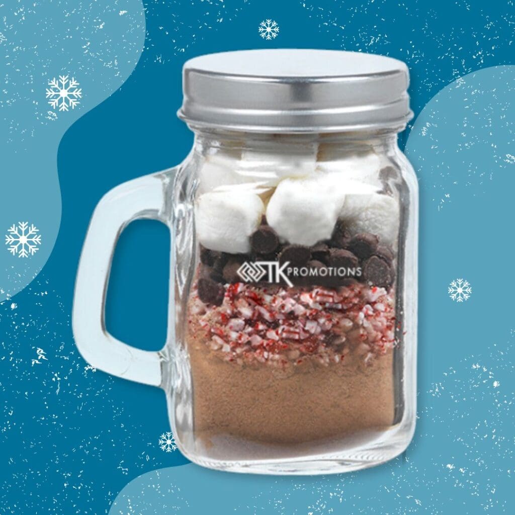 A cutsom mini mason jar filled with hot cocoa mix and toppings