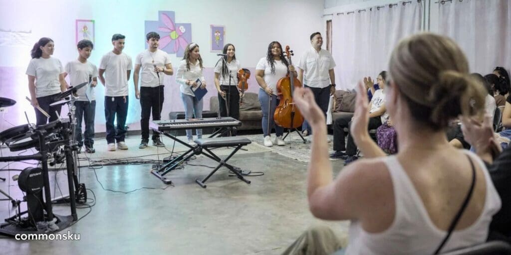 A photo of a promotional product distributor clapping after a performance in Honduras.