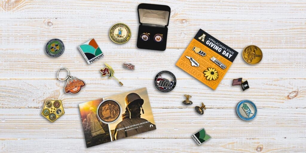 Assorted collectible items including pins, coins, and keychains used in branded merchandise programs