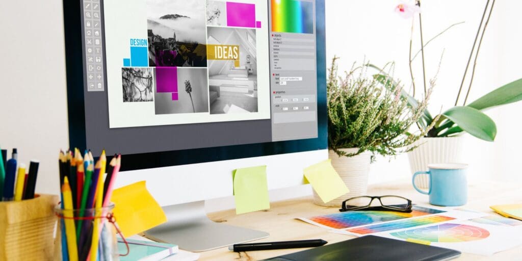 Graphic design workspace showing digital design concepts, color references, and creative planning materials.